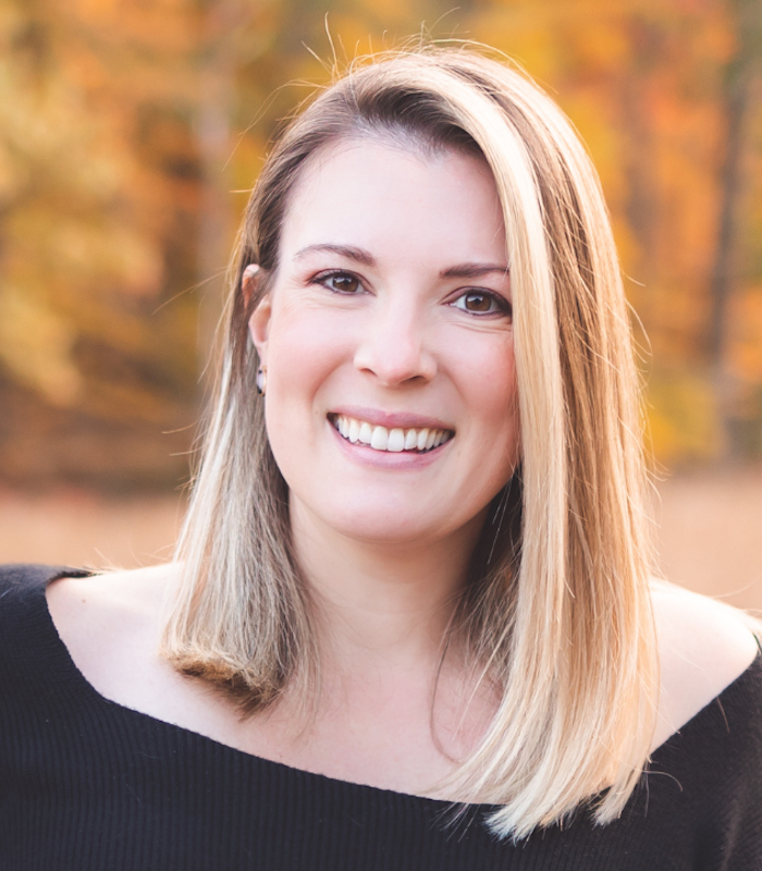 About Our Agency - Smiling Businesswoman Helping Clients at Her Desk